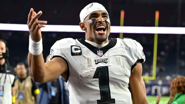 Eagles quarterback Jalen Hurts (1) walks off the field in celebration at the end of a win over the Texans.